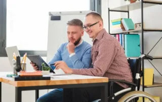 individuals working together at an office desk