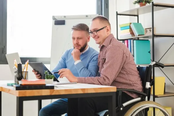 individuals working together at an office desk