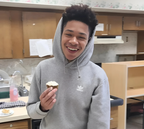 Elijah Jackson smiling with a cupcake