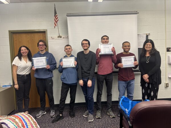 four students who are disabled holding certificates with IFG staff